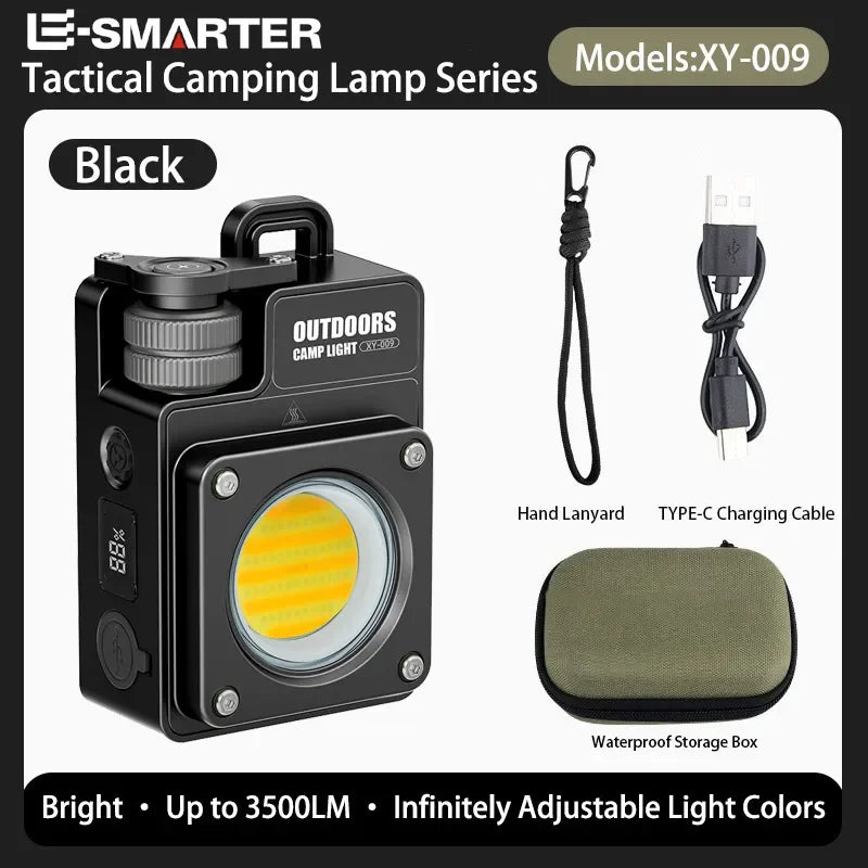 Black tactical camping lamp shown with included accessories: a hand lanyard, a USB-C charging cable, and a waterproof storage box on a white background with E-SMARTER branding.