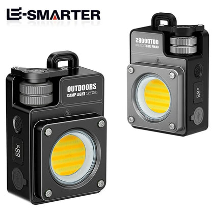 Two views of a black and gray E-SMARTER outdoor COB camp light on a white background, showing the front with the illuminated yellow COB LED lens and the side with the digital display.
